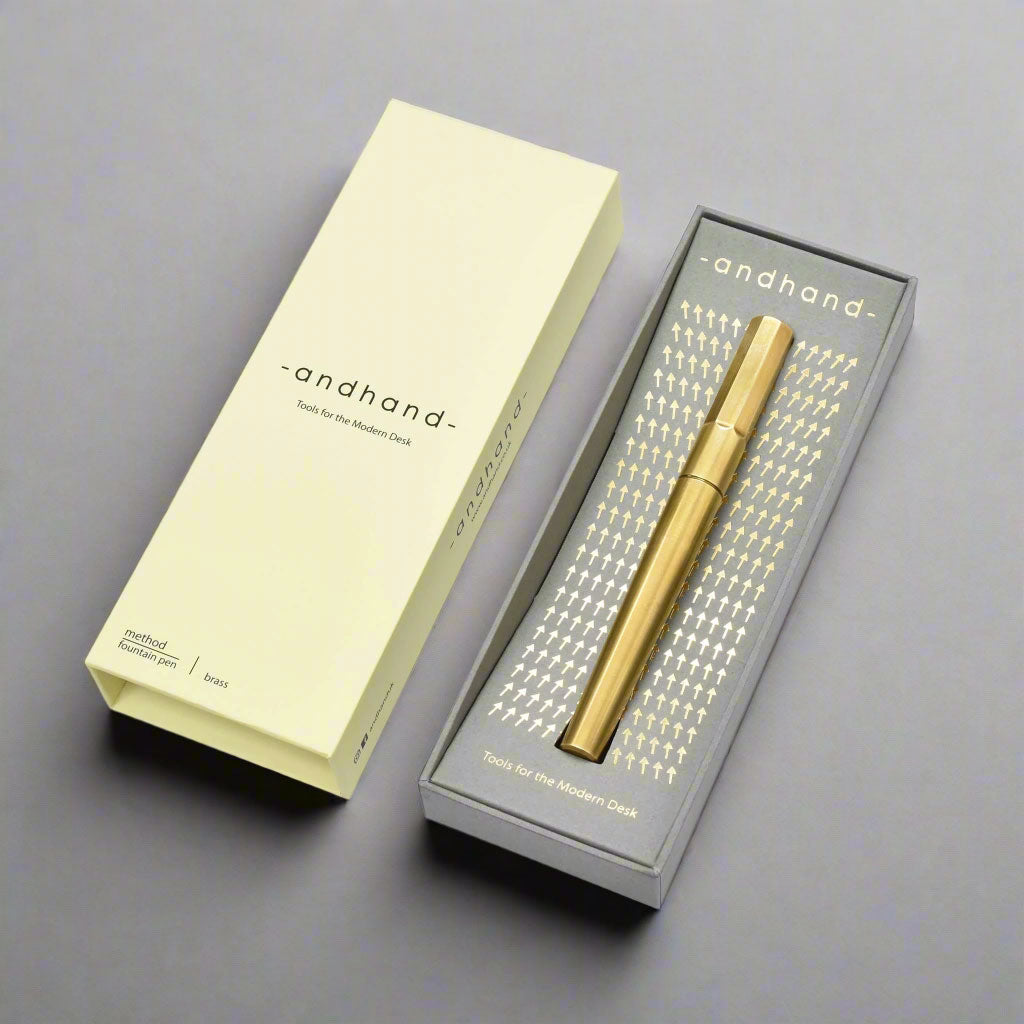 Solid brass method fountain pen presented in premium card box with gold foiled pattern.